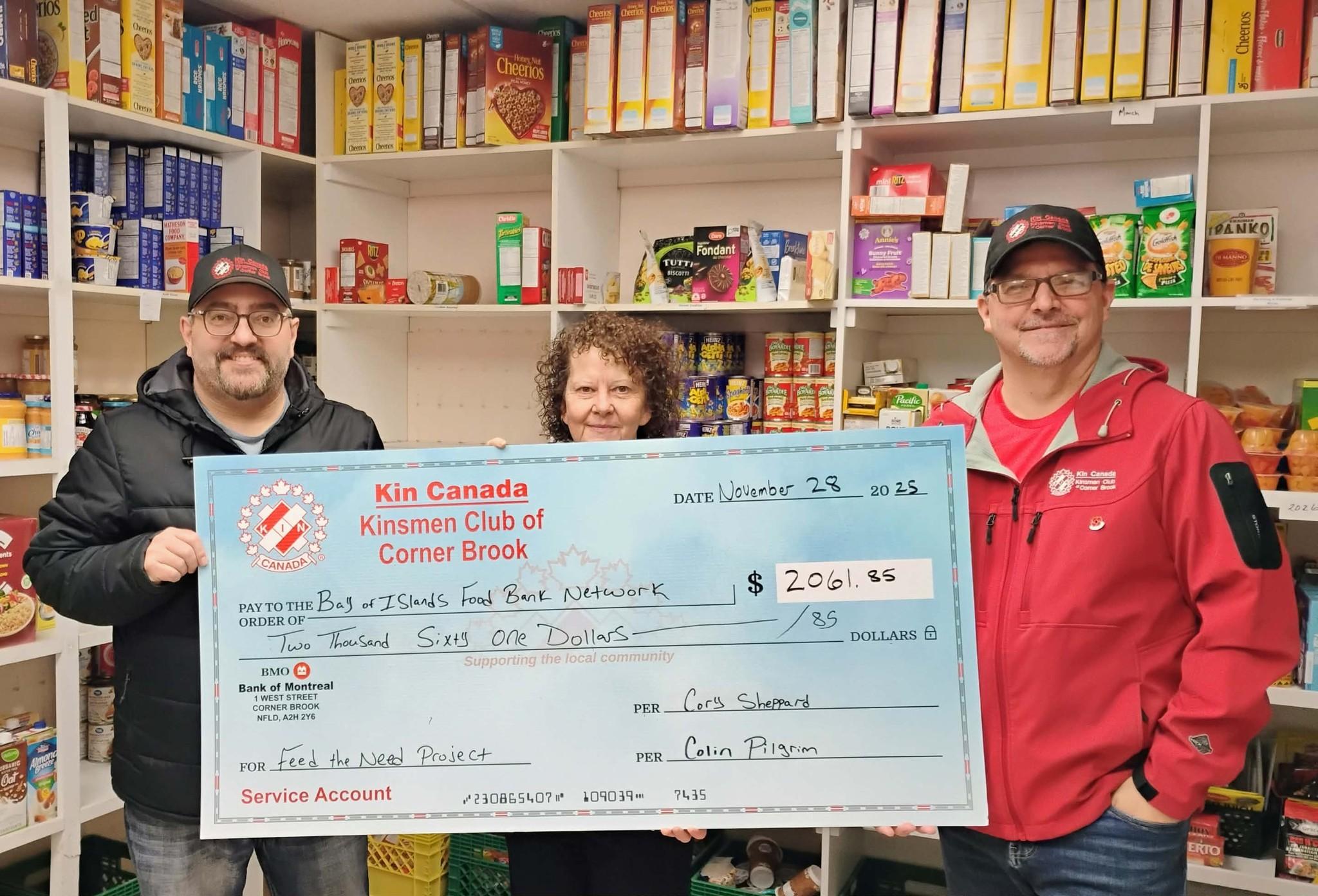 Volunteers with a large donation check